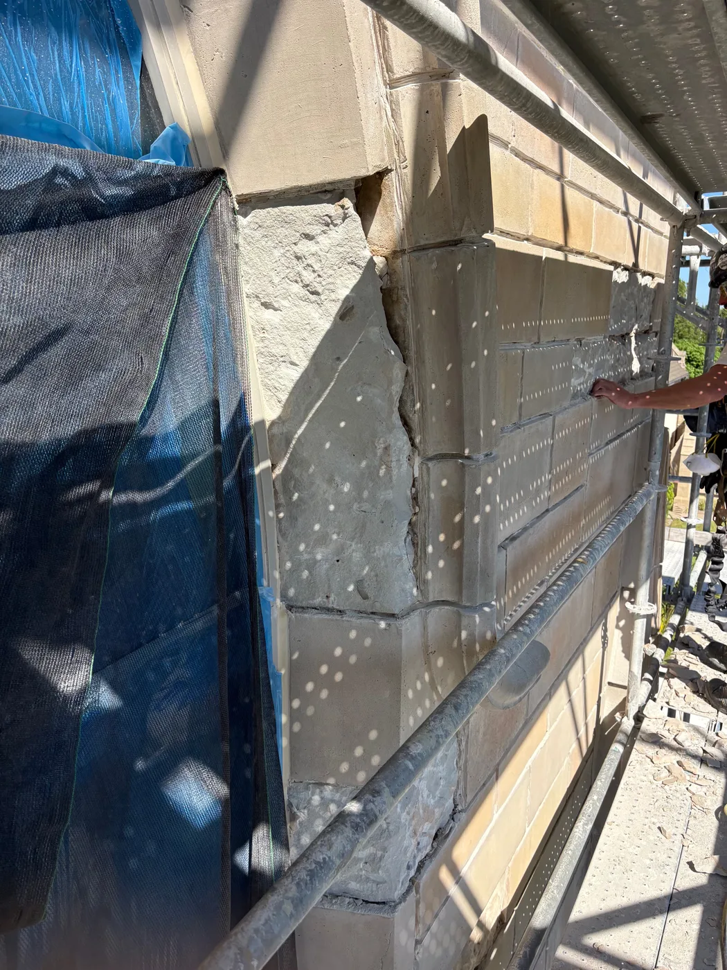 Close view of damaged stone being repaired and the joints repointed at Bethesda-by-the-Sea church in Palm Beach, Florida.