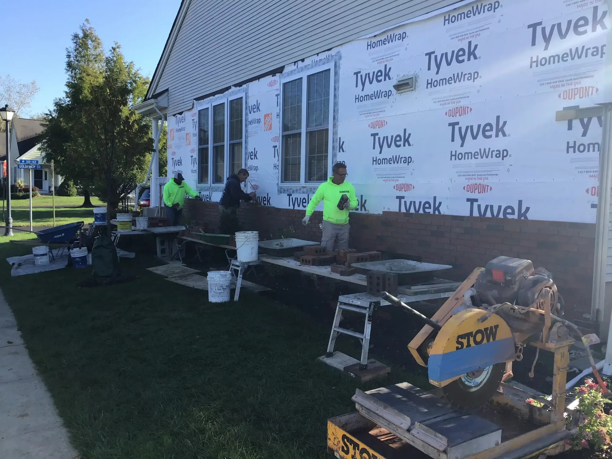 A. Pennacchi & Sons crew laying brick on the side of a home